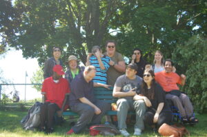 Pegasus Participants and staff are pictured smiling. They are outside in front of trees.