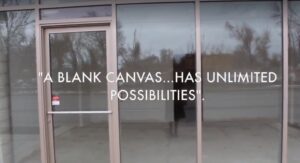 Photo of large glass windows and door. Text overlay reads "A blank canvas... has unlimited possibilities".
