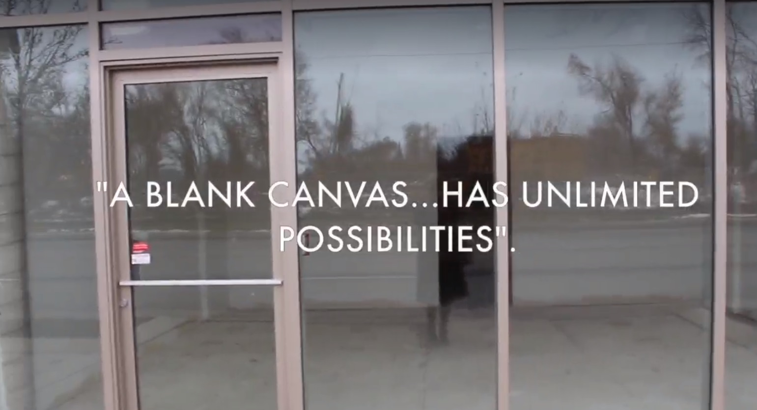 Photo of large glass windows and door. Text overlay reads "A blank canvas... has unlimited possibilities".