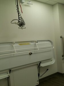 Image shows Danforth location's accessible washroom with sling and table.